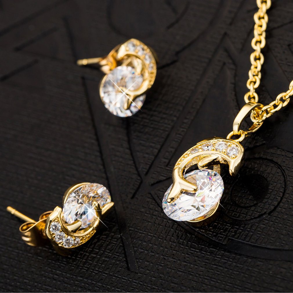Creative dolphin necklace pendant and rhinestone earrings set by eprolo, featuring dolphin designs and sparkling stones.
