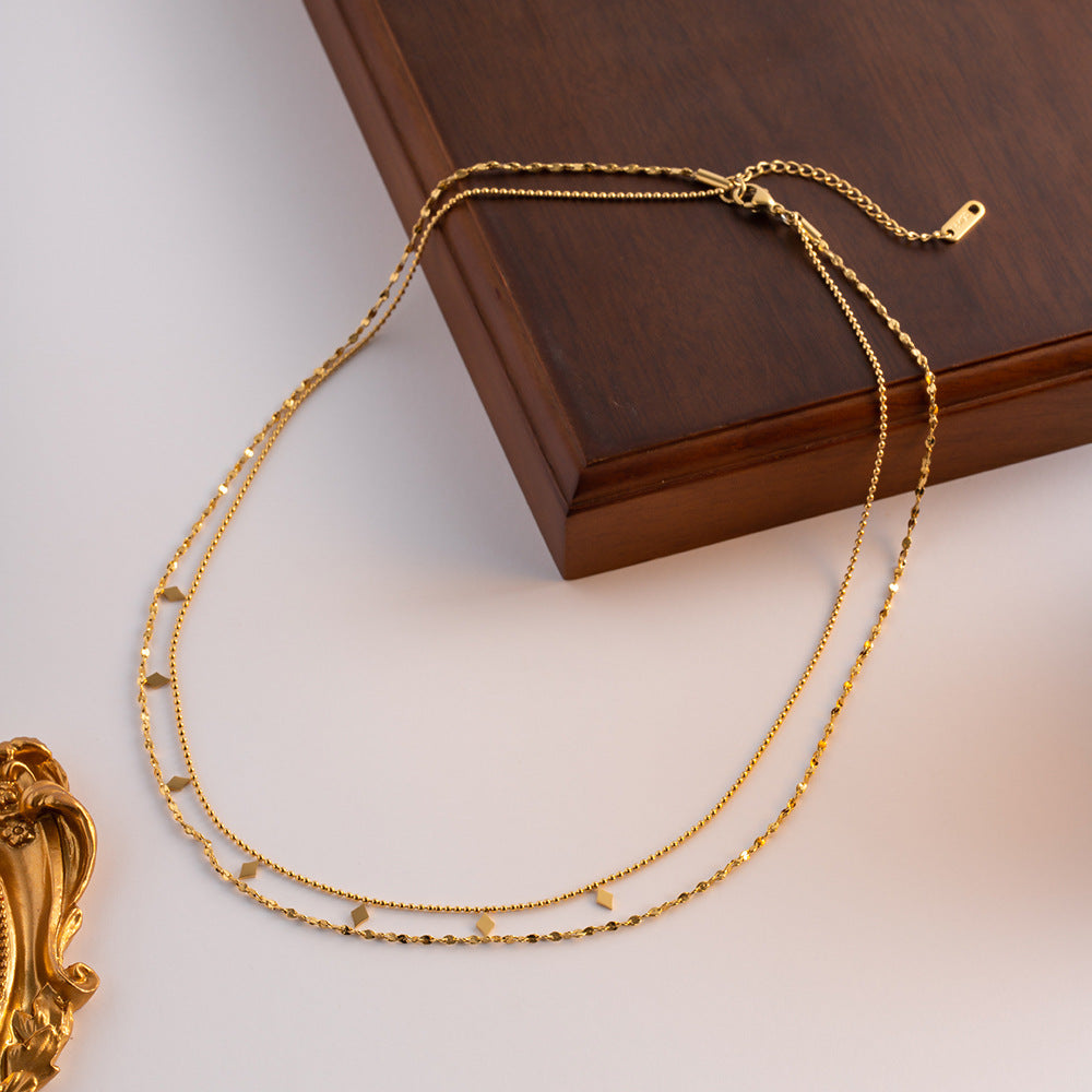 Double-layer tassel collarbone necklace in French style with delicate chains and hanging tassels, stylish jewelry by eprolo.
