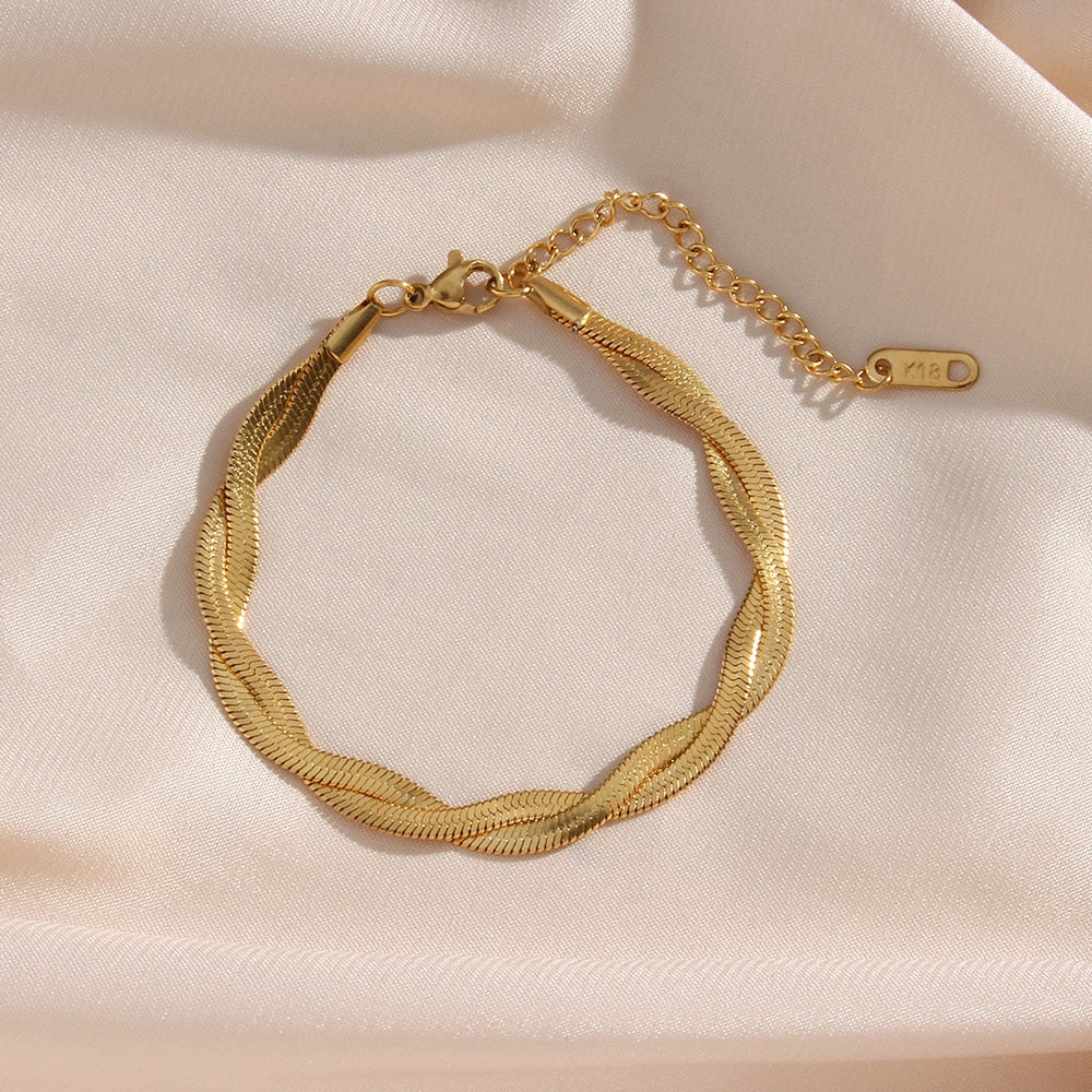 Eprolo 18K gold plated herringbone chain necklace and bracelet set showing the shiny, flexible jewelry on a white background.