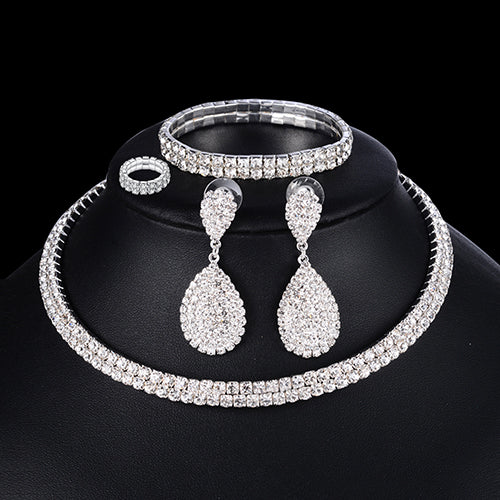 Elegant luxury wedding bridal jewelry set featuring earrings, necklace, and bracelet with sparkling crystals and intricate design.