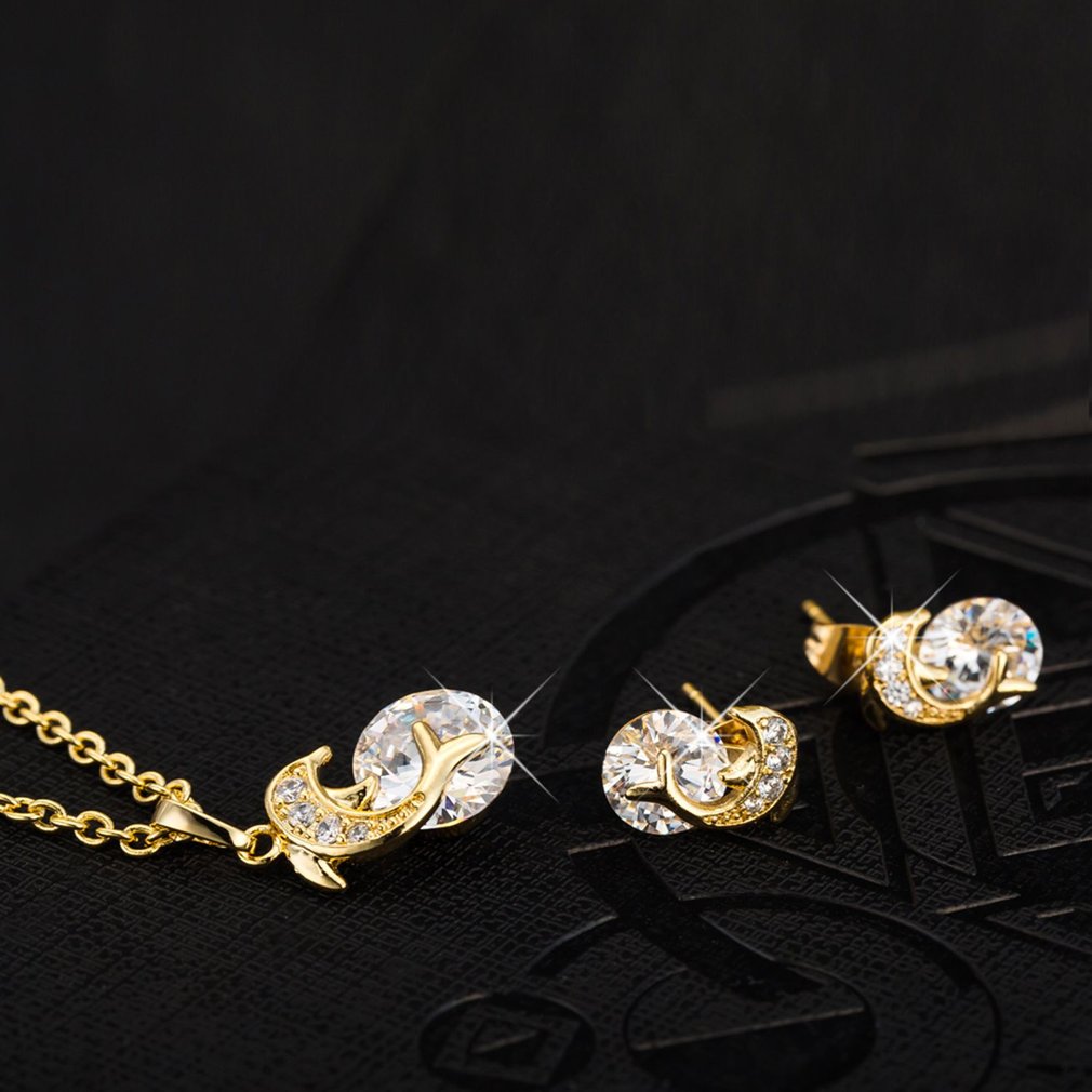 Eprolo creative dolphin necklace pendant with rhinestone earrings set, featuring silver-tone metal and sparkling embellishments.