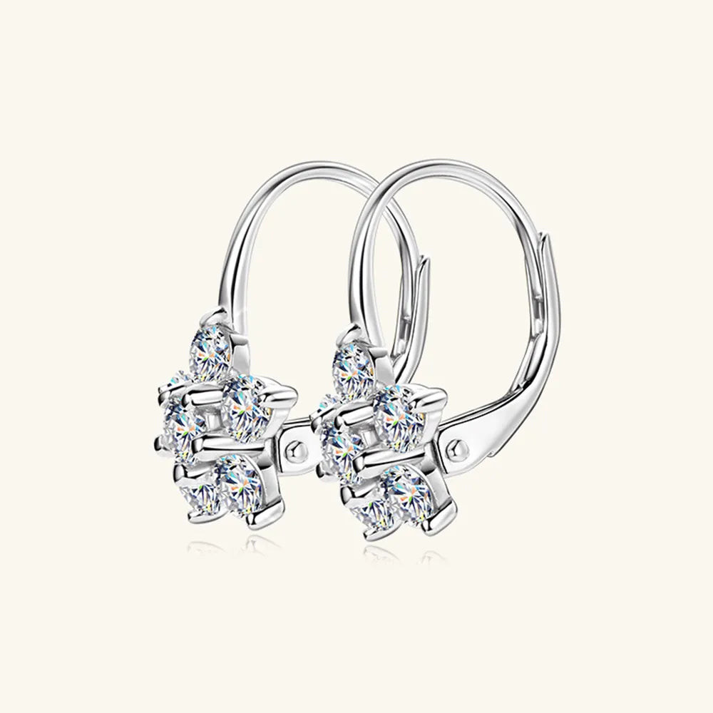 Sterling silver moissanite flower huggie earrings with 1.2 carats, featuring sparkling gemstone details and a secure clasp.