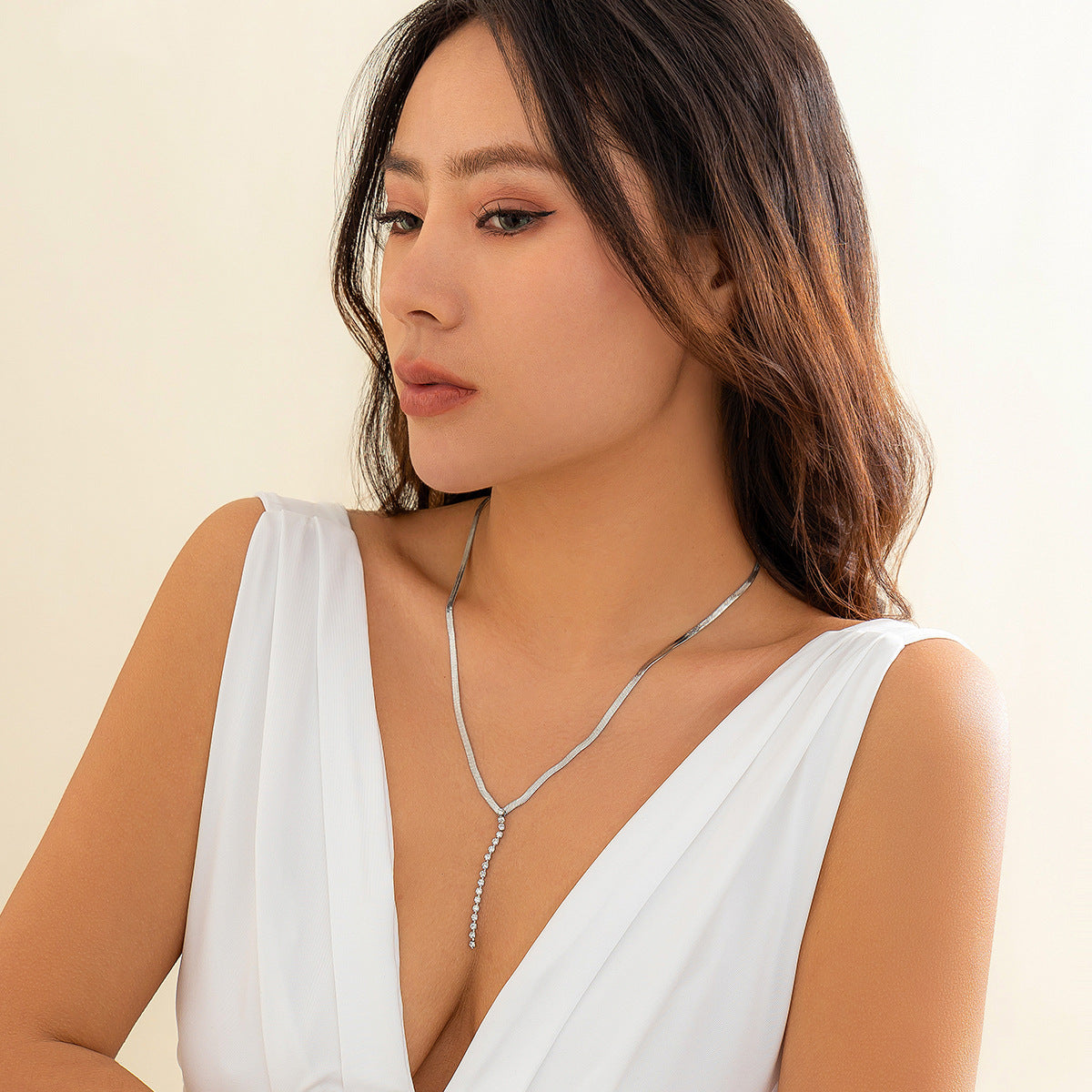 Gold tone Snake Bone Y-Drop Crystal Tassel Necklace featuring a snake bone design and sparkling crystal tassels.