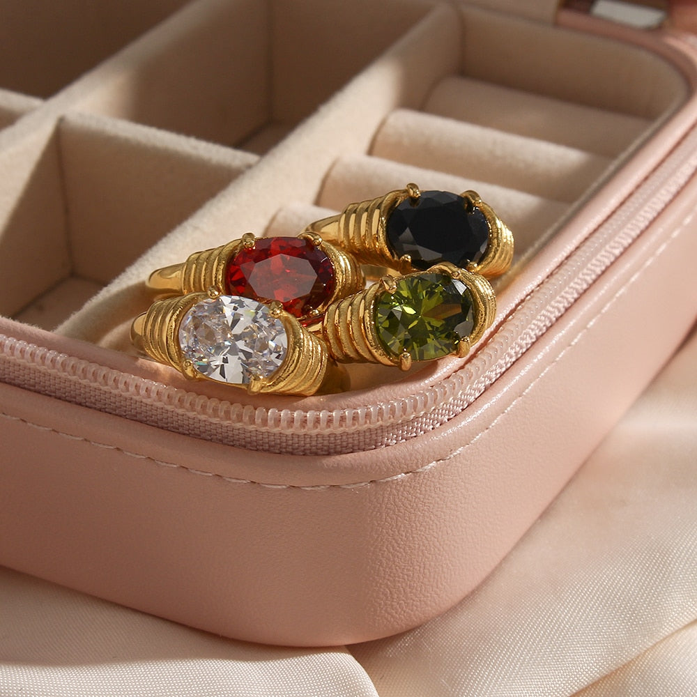 Oval-cut 3A zircon ring in 18K gold plated prong setting, showcasing a sparkling gemstone on a polished band.