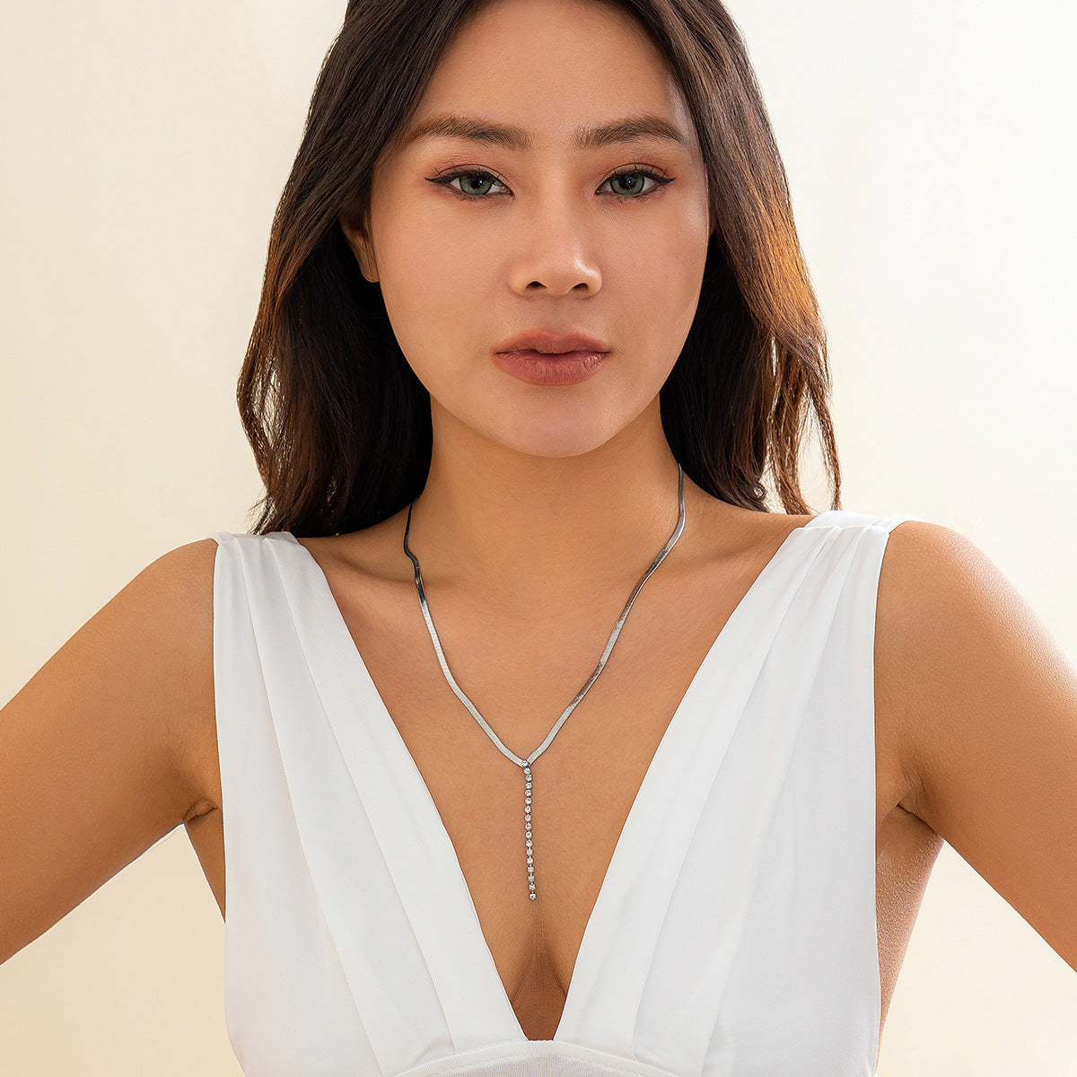 Gold tone Snake Bone Y-Drop Crystal Tassel Necklace featuring a snake bone pendant and sparkling crystal tassel.