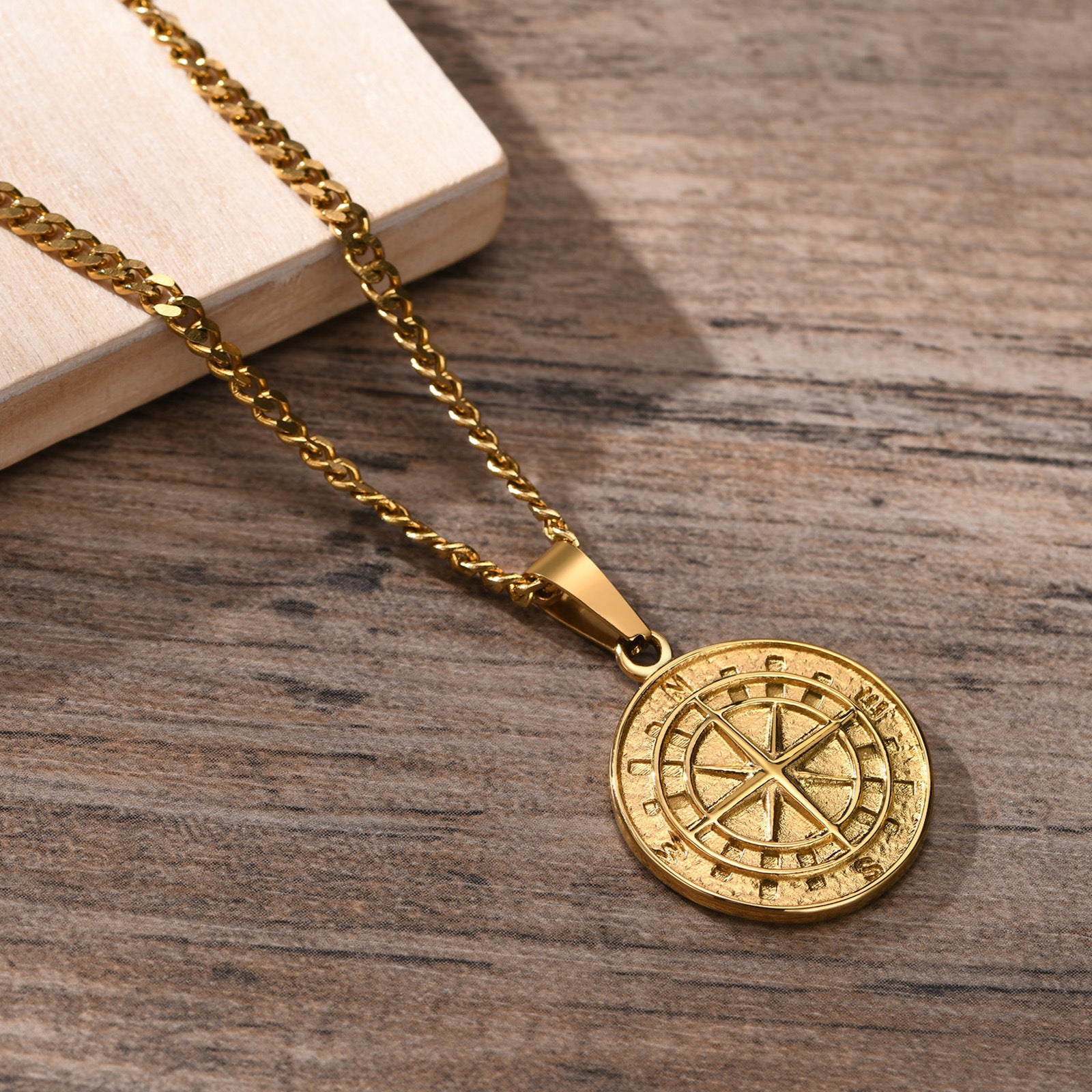 Gold compass coin pendant necklace for men, hip hop style, featuring a detailed compass design on a sleek chain.